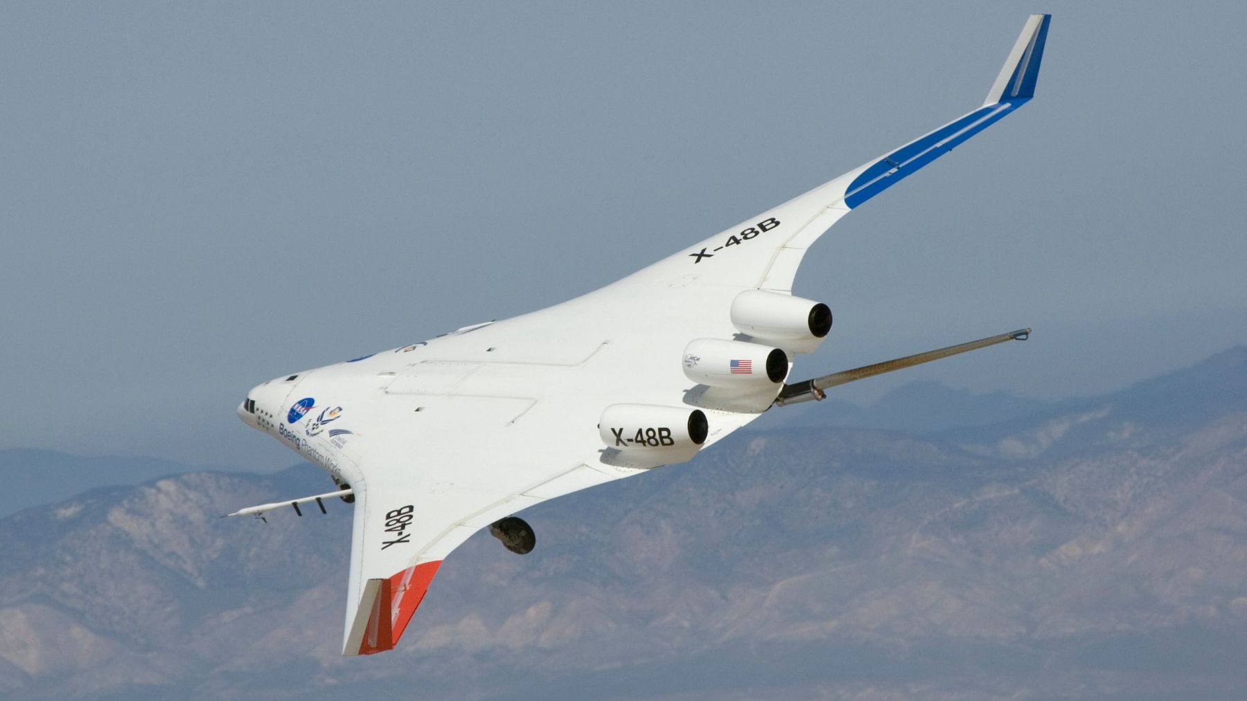 A blended wing body research aircraft banking in flight, its centre body merging into the wings