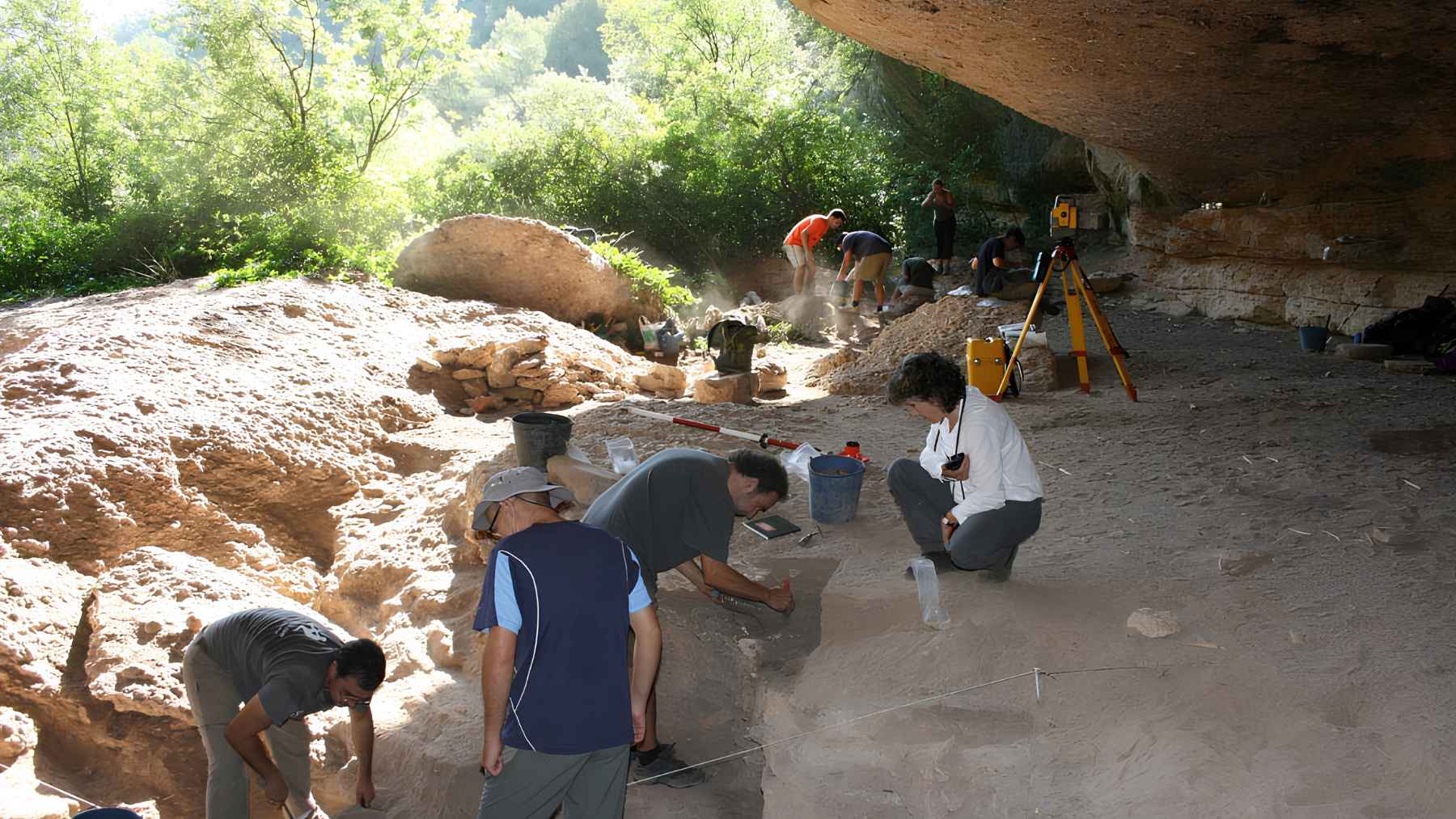 Archaeologists excavating the Coves del Fem prehistoric rock shelter in northeastern Spain.