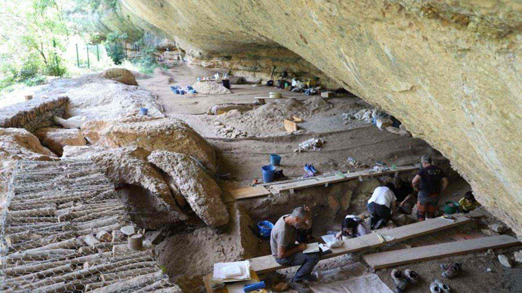 Archaeologists excavate storage pits and hearths inside the Coves del Fem rock shelter in Ulldemolins, Spain.