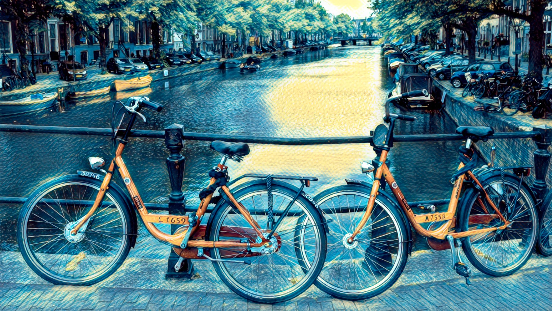 People cycling along a canal street in Amsterdam, Netherlands