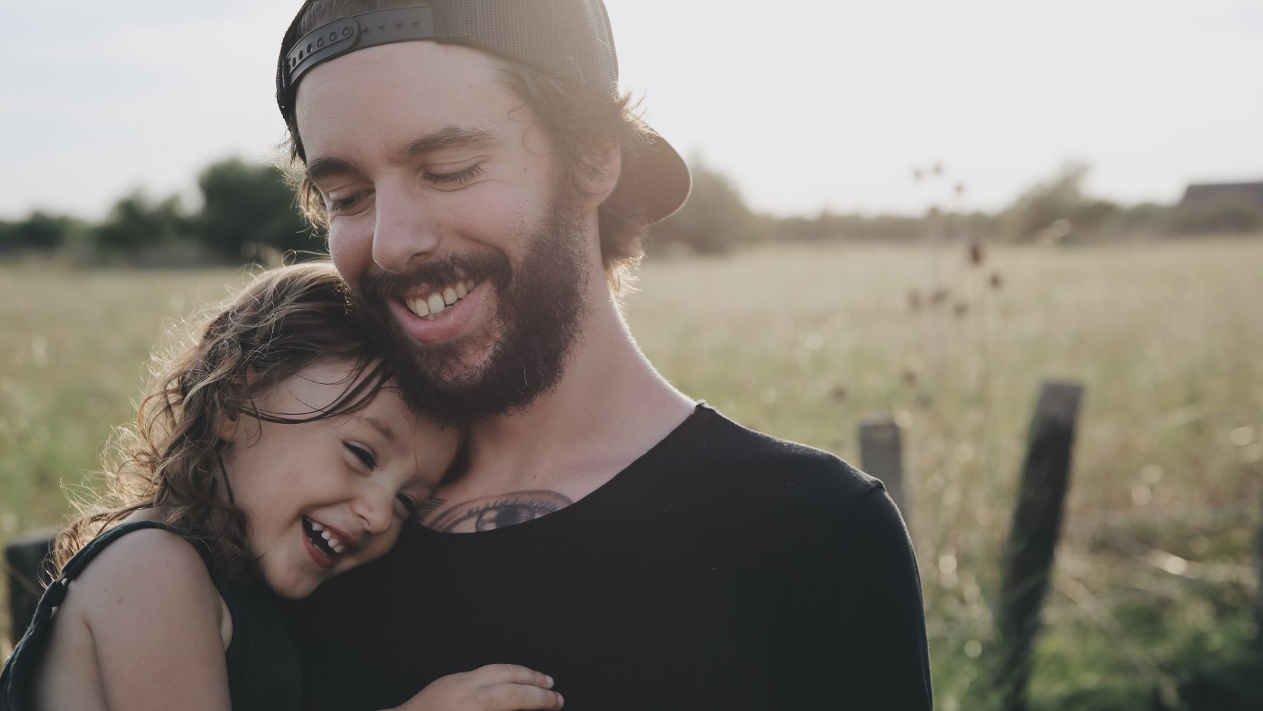 Father hugging his young daughter outdoors