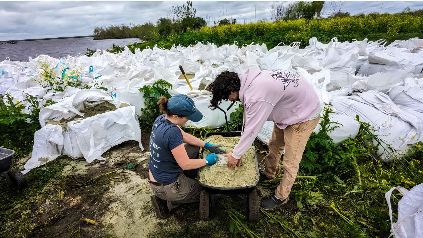 Workers handle recycled glass sand during a coastal restoration project in Louisiana.