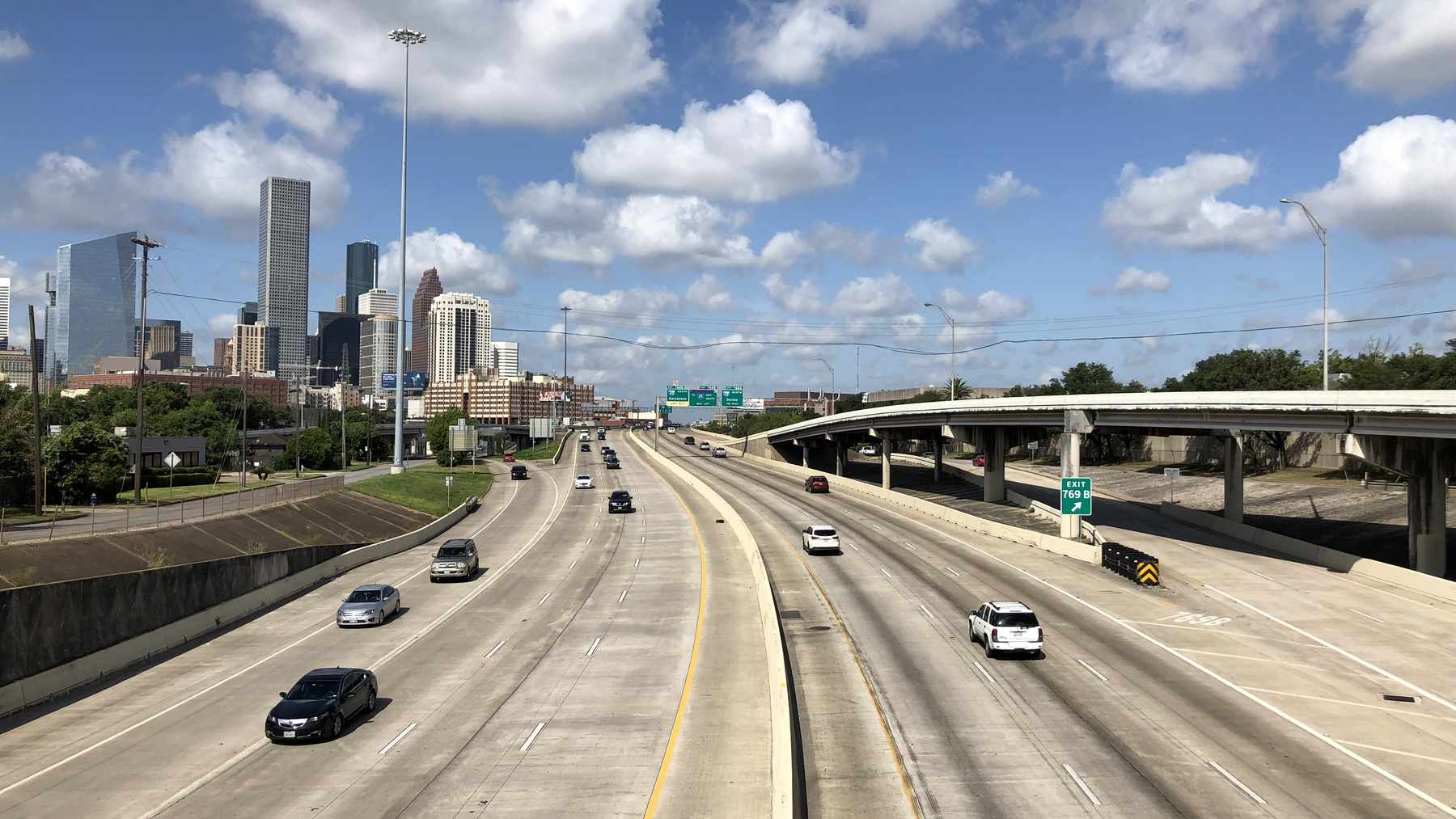 Interstate 10 approaches downtown Houston with the city skyline in view.