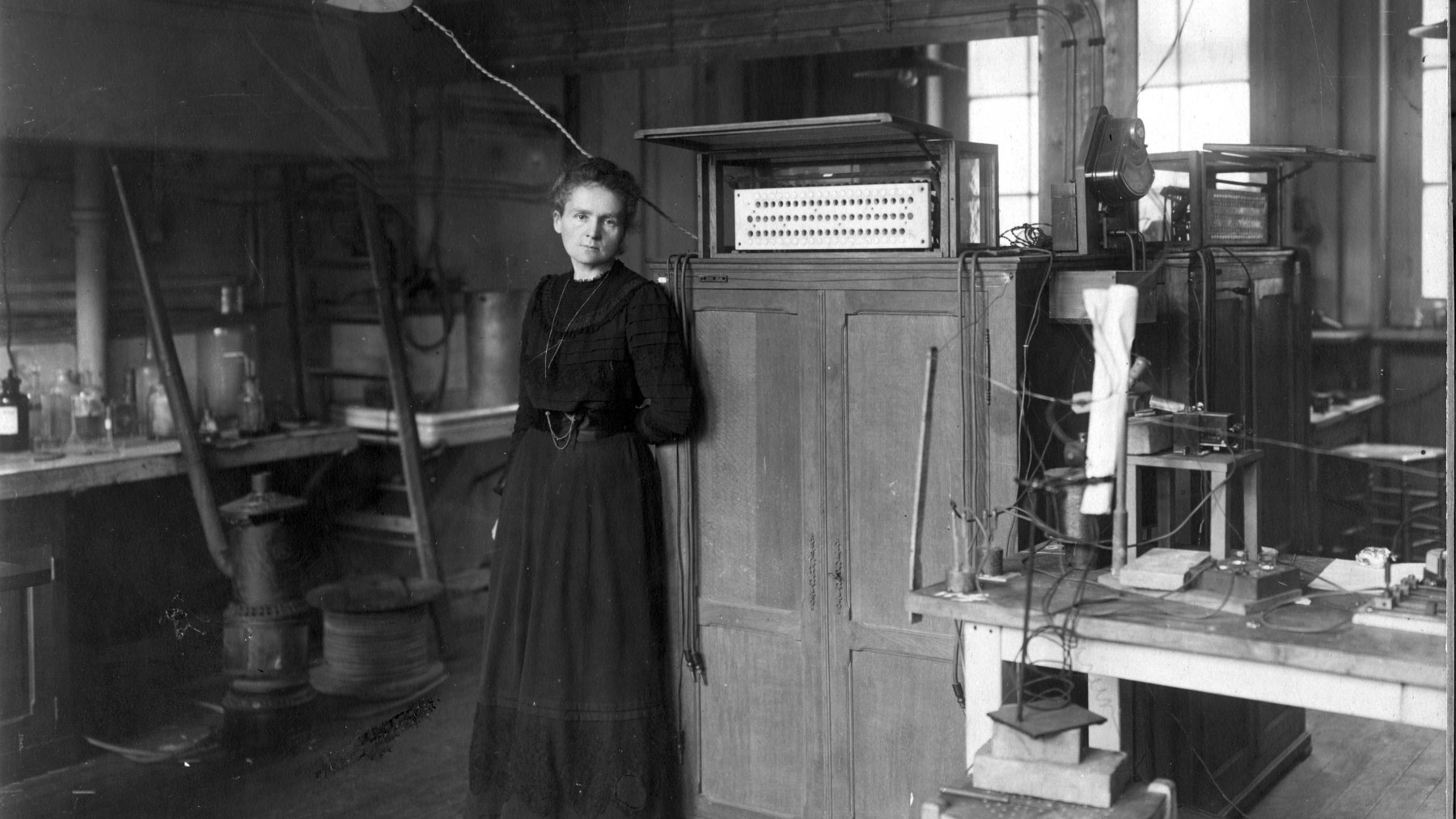 Black and white photo of Marie Curie working in her Paris laboratory in 1912