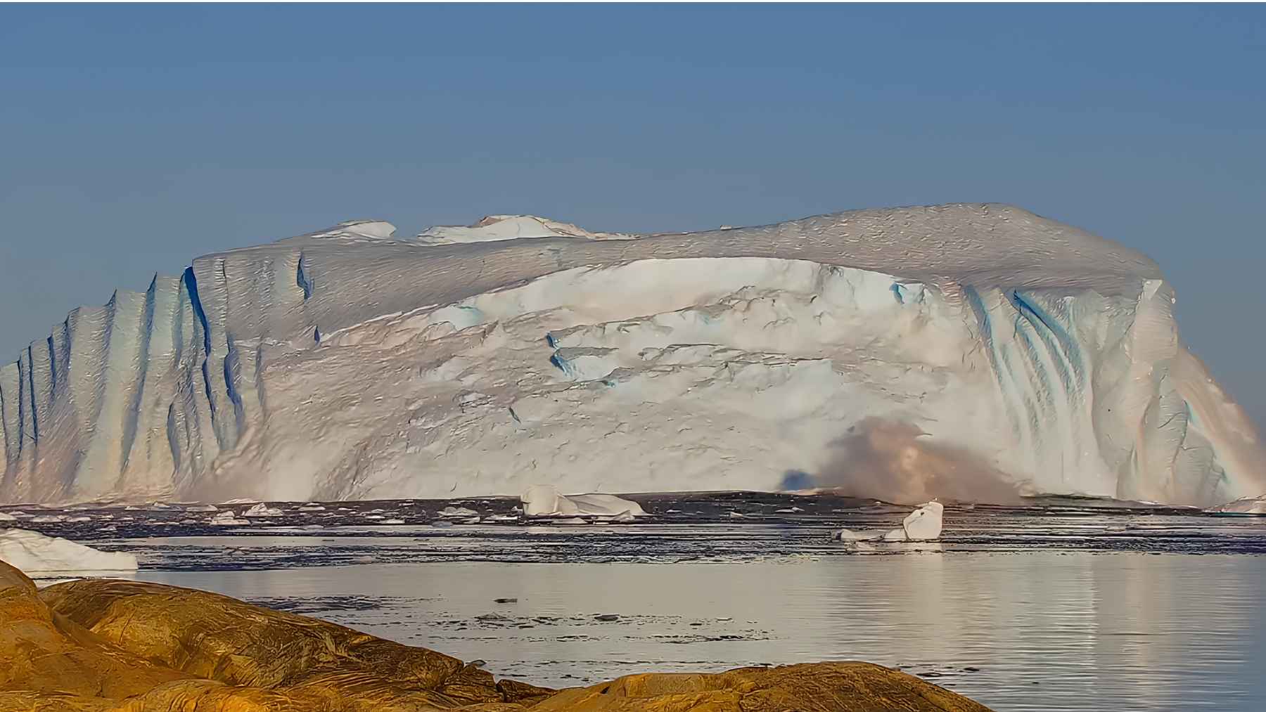 Massive iceberg during a rollover near Ilulissat Icefjord in Greenland.