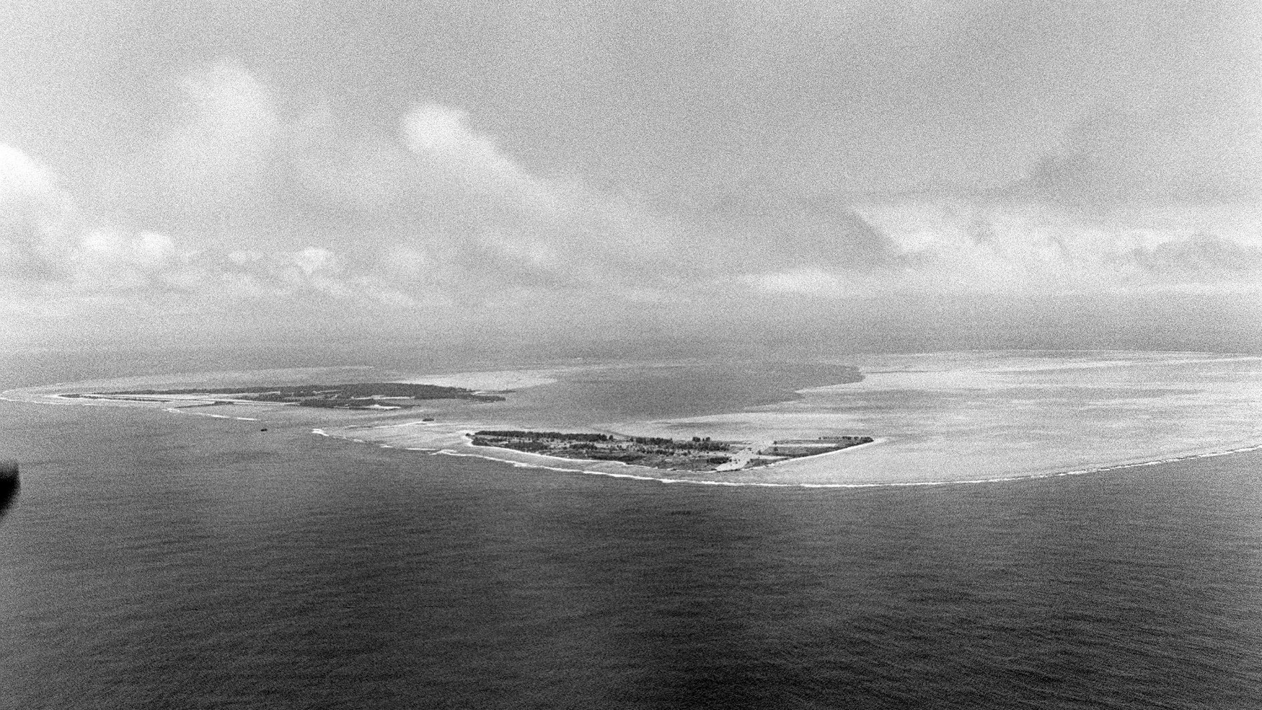 Aerial view of Midway Atoll surrounded by turquoise lagoon water