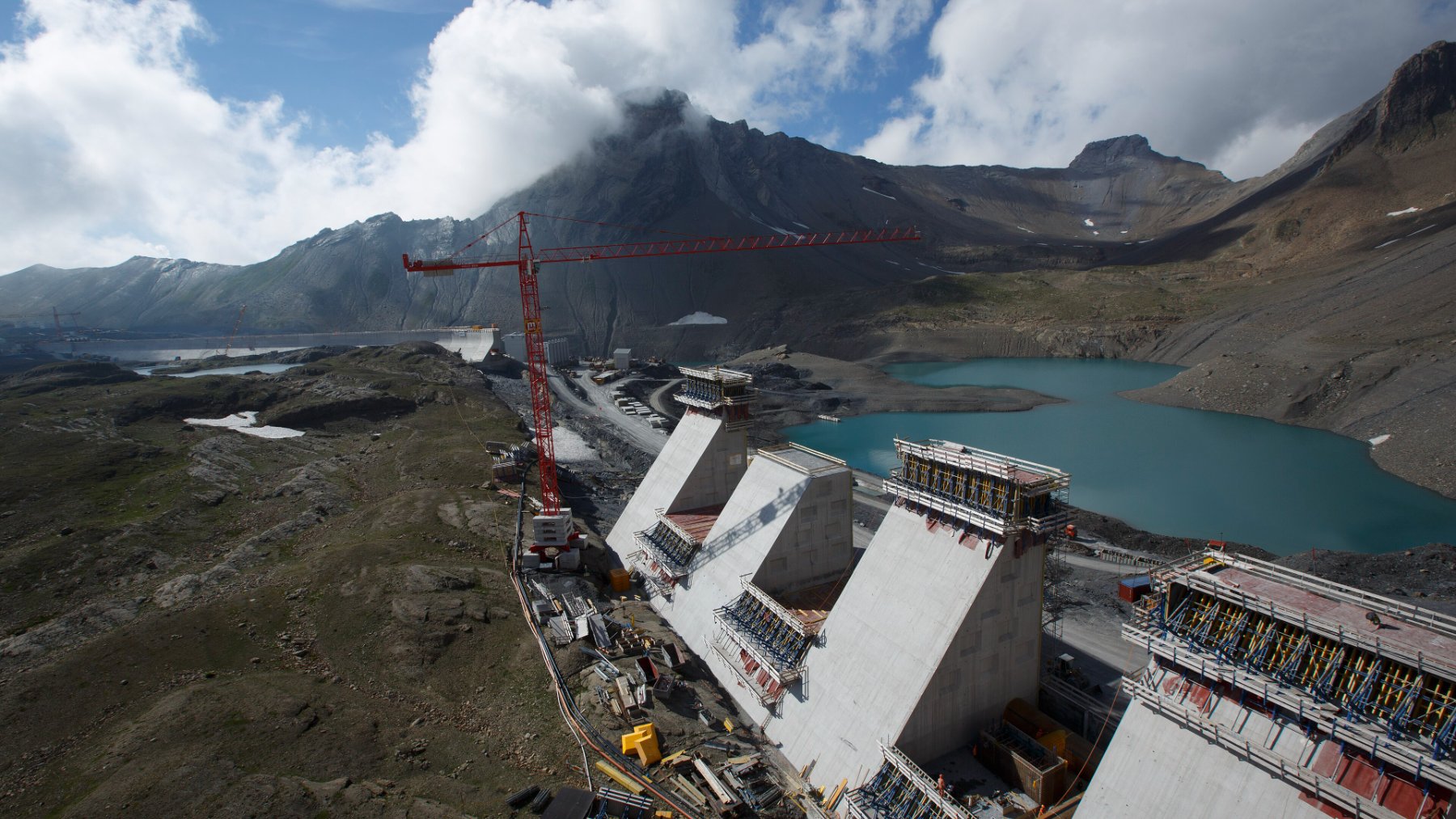 Muttsee dam wall high in the Swiss Alps above a mountain lake