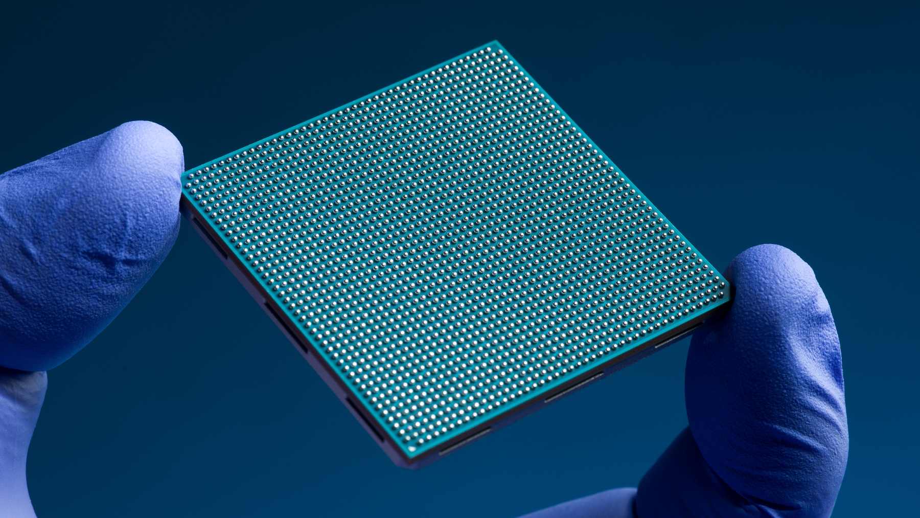 NASA's High Performance Spaceflight Computing processor held in a gloved hand.