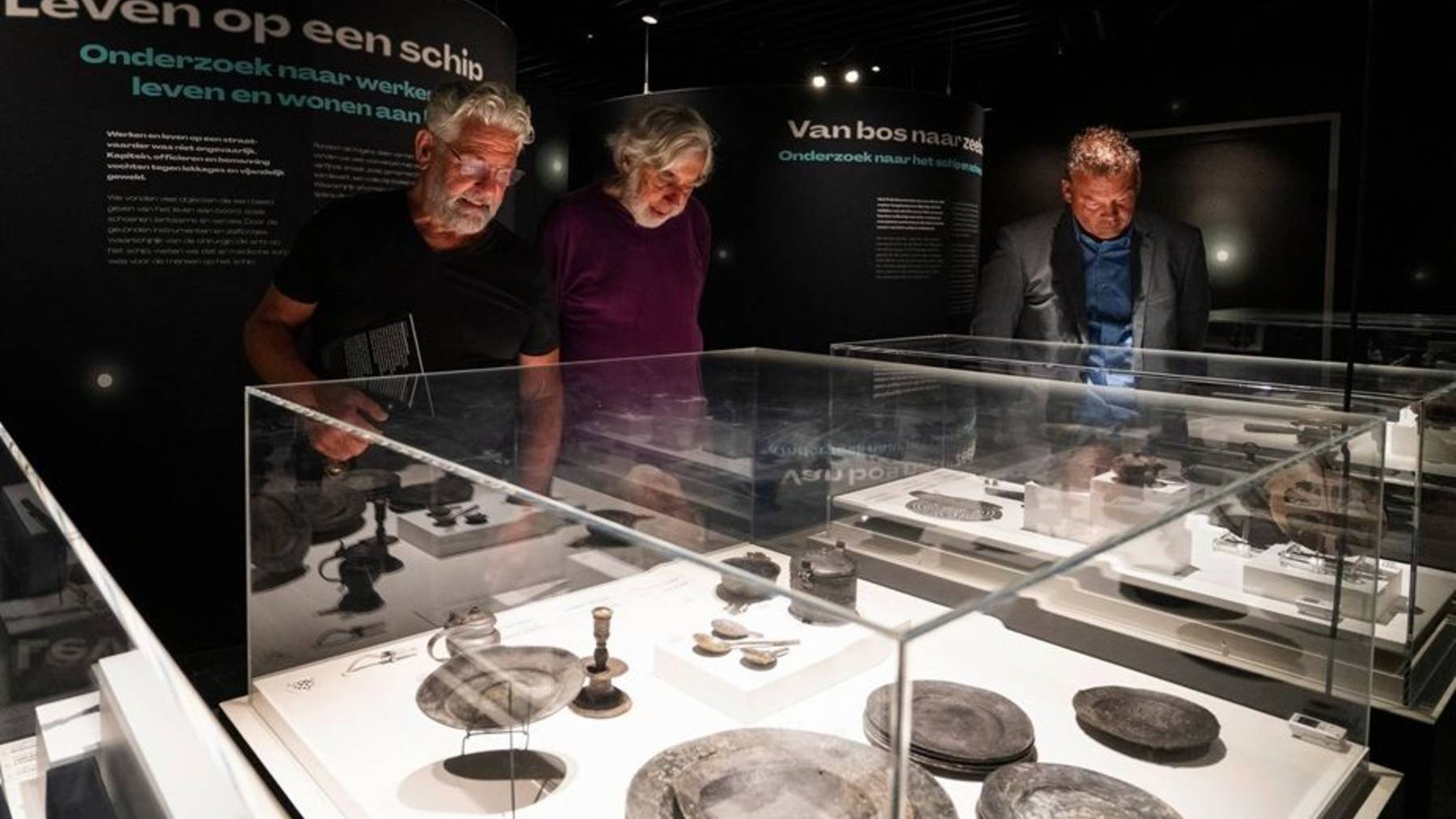 Visitors looking at finds from the Palmhout wreck in a museum