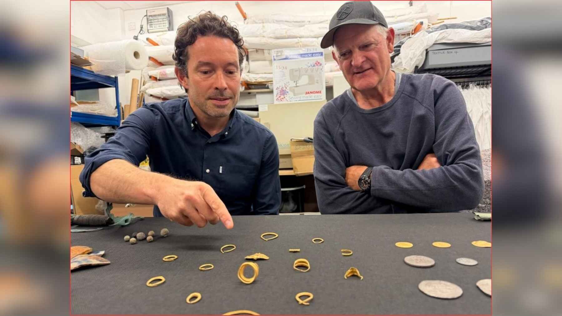Todd Stevens and Xavier Duffy examining artifacts recovered from the 1680 Phoenix shipwreck near the Isles of Scilly.