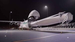 Concept rendering of Radia’s WindRunner cargo aircraft loading a giant wind turbine blade at night