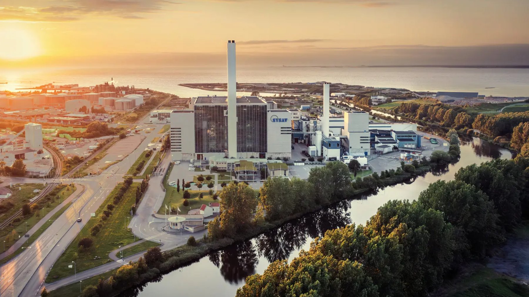 Aerial view of the Sysav waste-to-energy plant in Malmö, Sweden, at sunset beside a canal