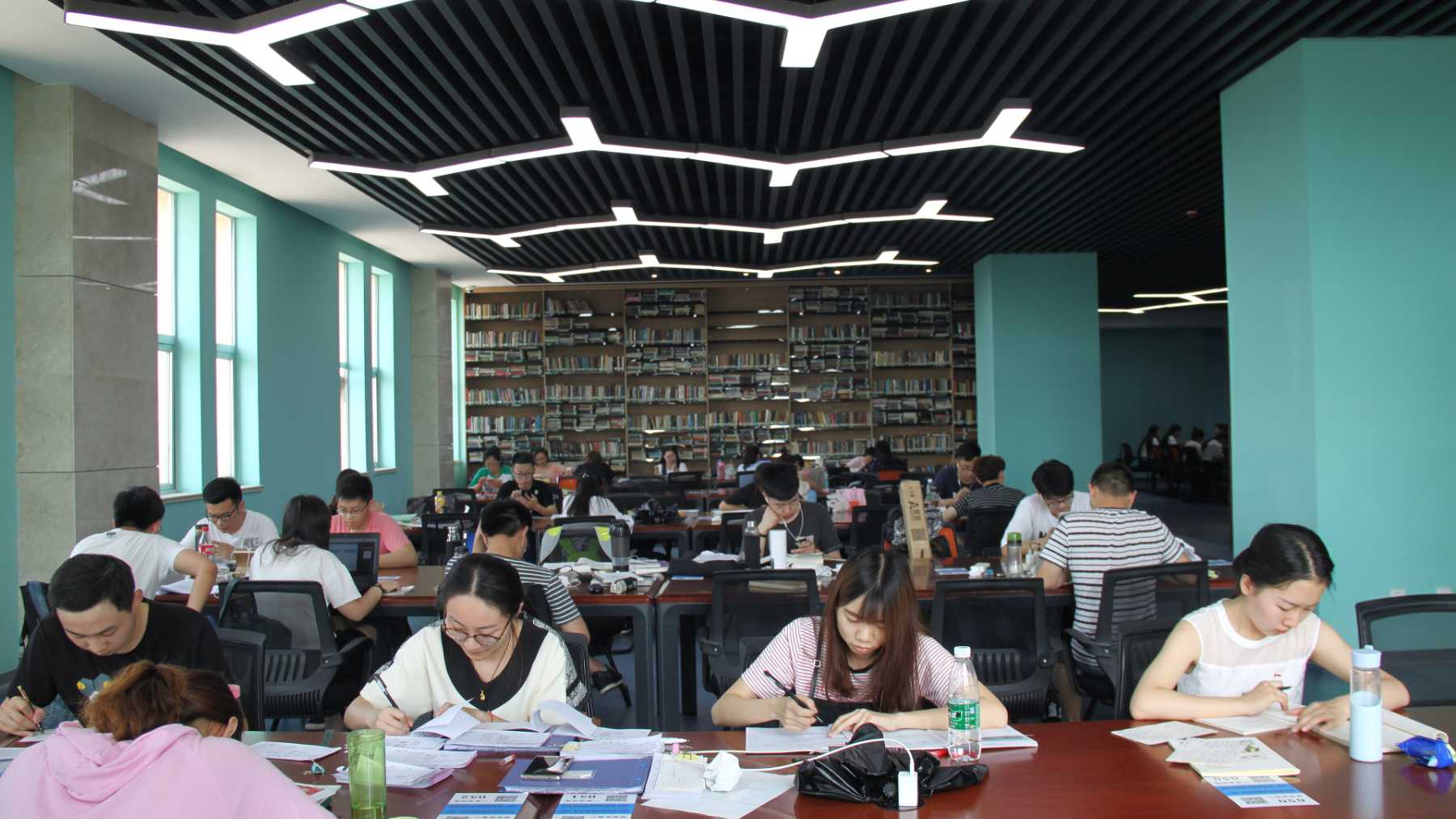 University students sitting and studying in a library