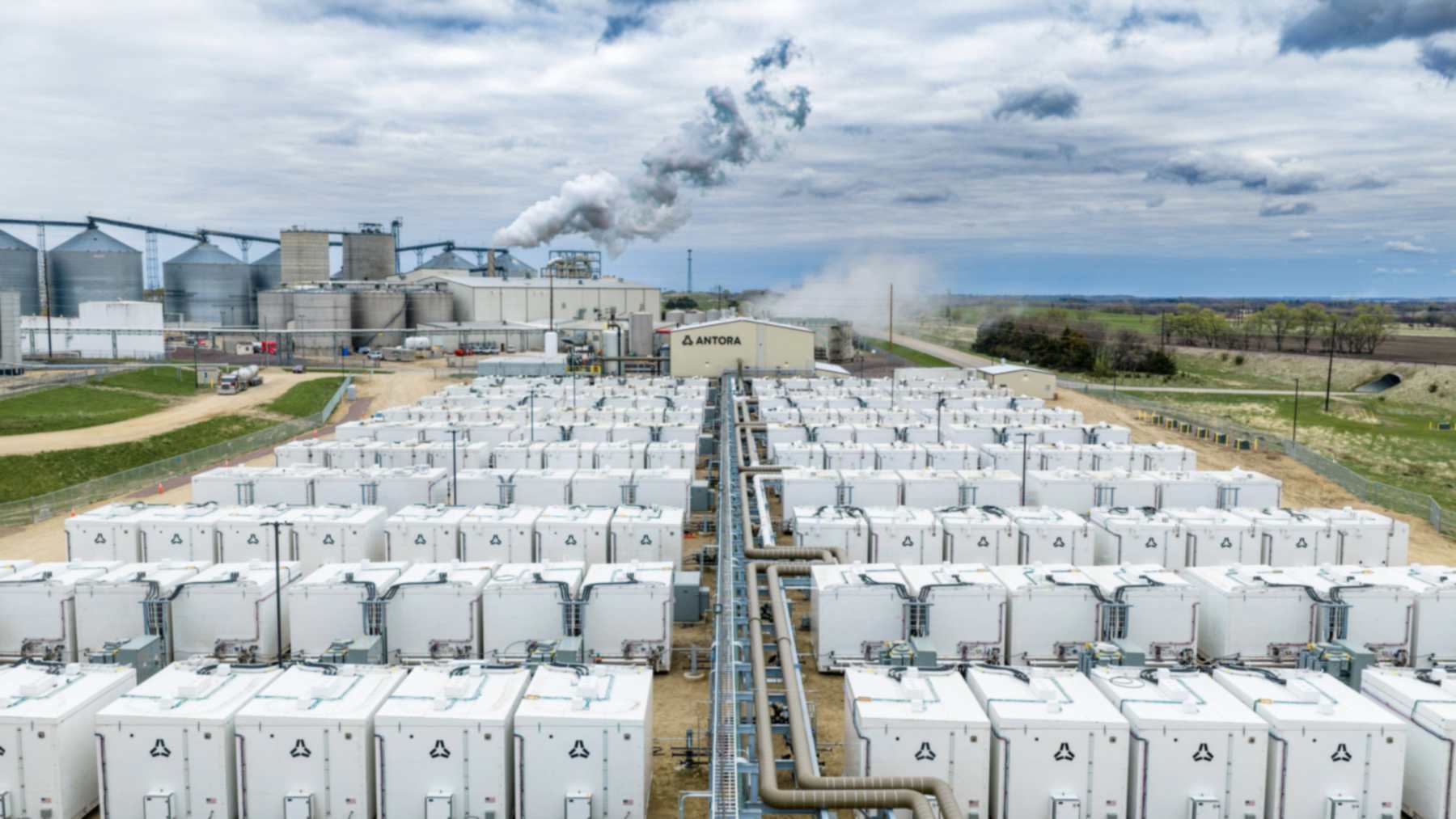 Antora thermal battery units beside POET's bioprocessing plant in Big Stone City, South Dakota, with steam rising behind them
