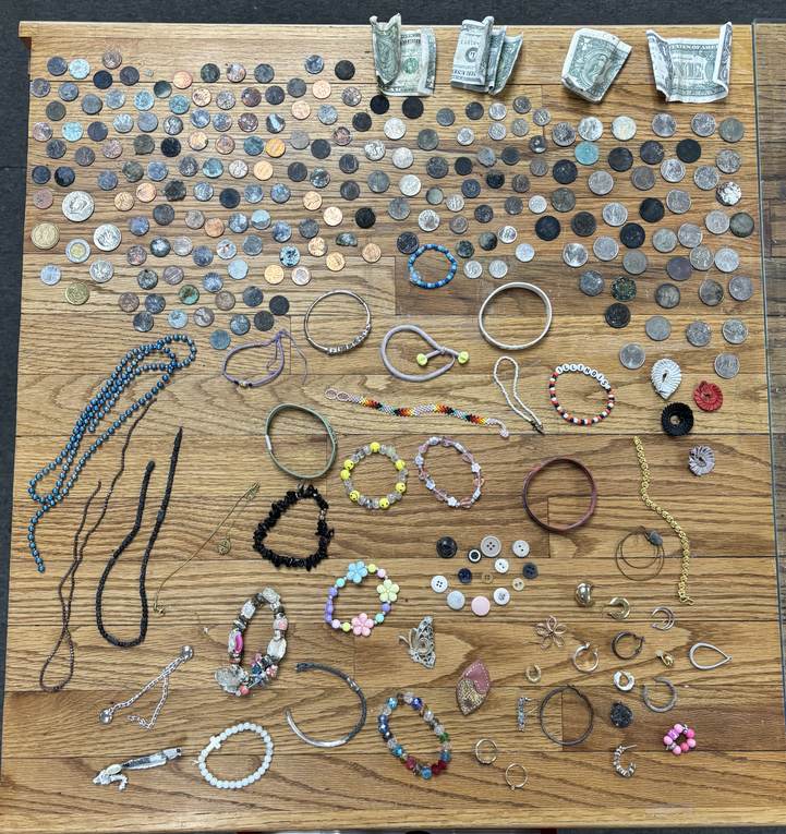 Coins, dollar bills and jewelry collected from Yellowstone hot springs and thermal areas in summer 2026