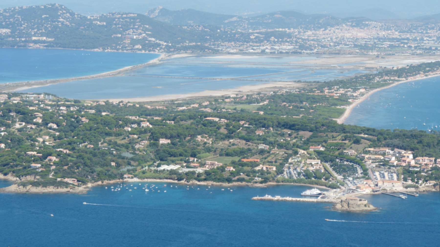Aerial view of the Giens peninsula with its two sand tombolos and the Hyères salt pans behind