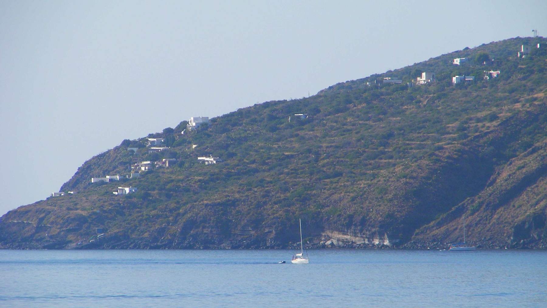 The hamlet of Ginostra on the green slopes of Stromboli seen from the sea