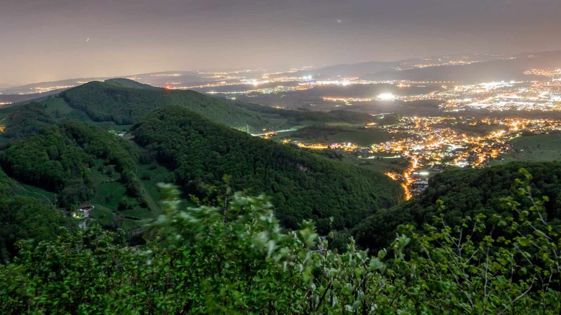 Night view over the Jurapark Aargau hills, where towns switched off lights against light pollution