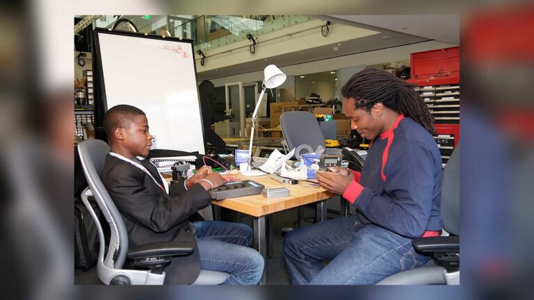 Kelvin Doe at a workbench with David Moinina Sengeh at MIT in 2012
