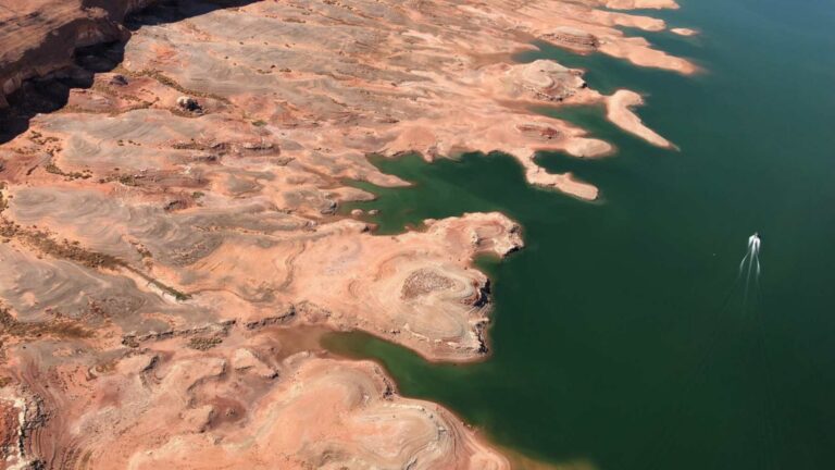 Aerial view of exposed sandstone shoreline and low water at Lake Powell near Bullfrog, Utah, in the Upper Colorado River Basin during the 2022 drought