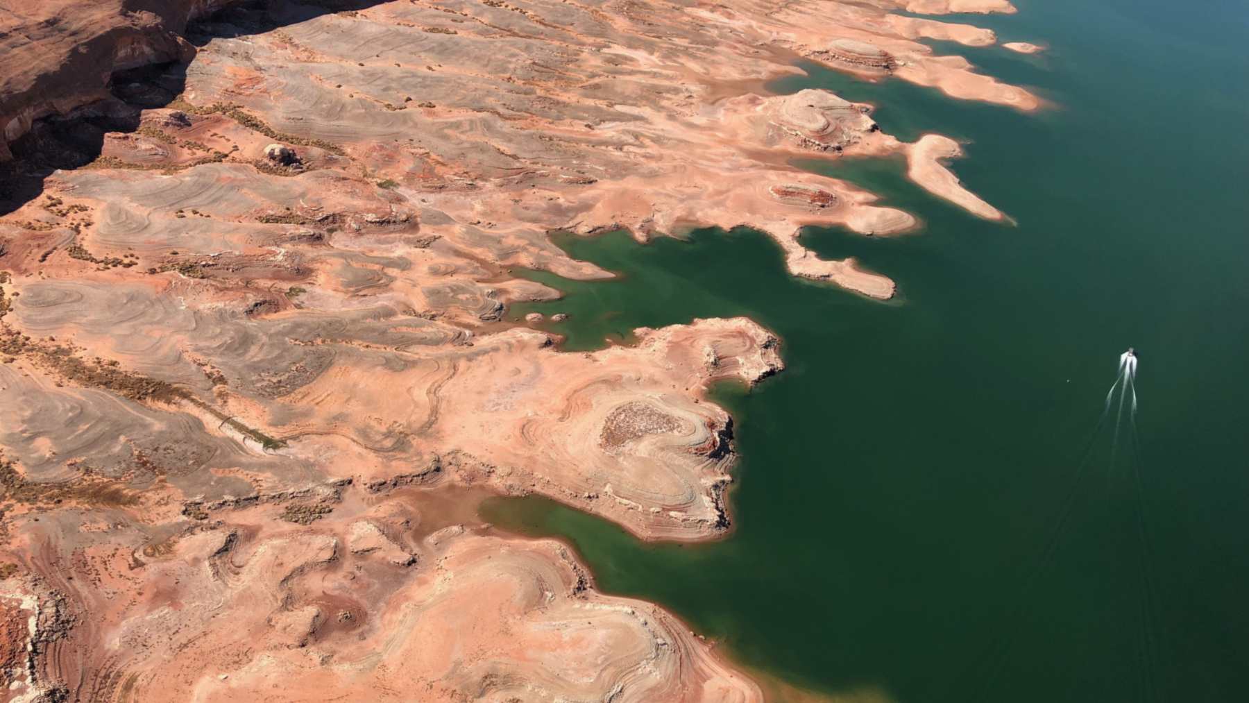 Aerial view of exposed sandstone shoreline and low water at Lake Powell near Bullfrog, Utah, in the Upper Colorado River Basin during the 2022 drought