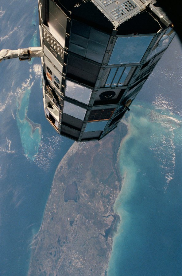 LDEF satellite on Challenger's robotic arm above Florida in April 1984