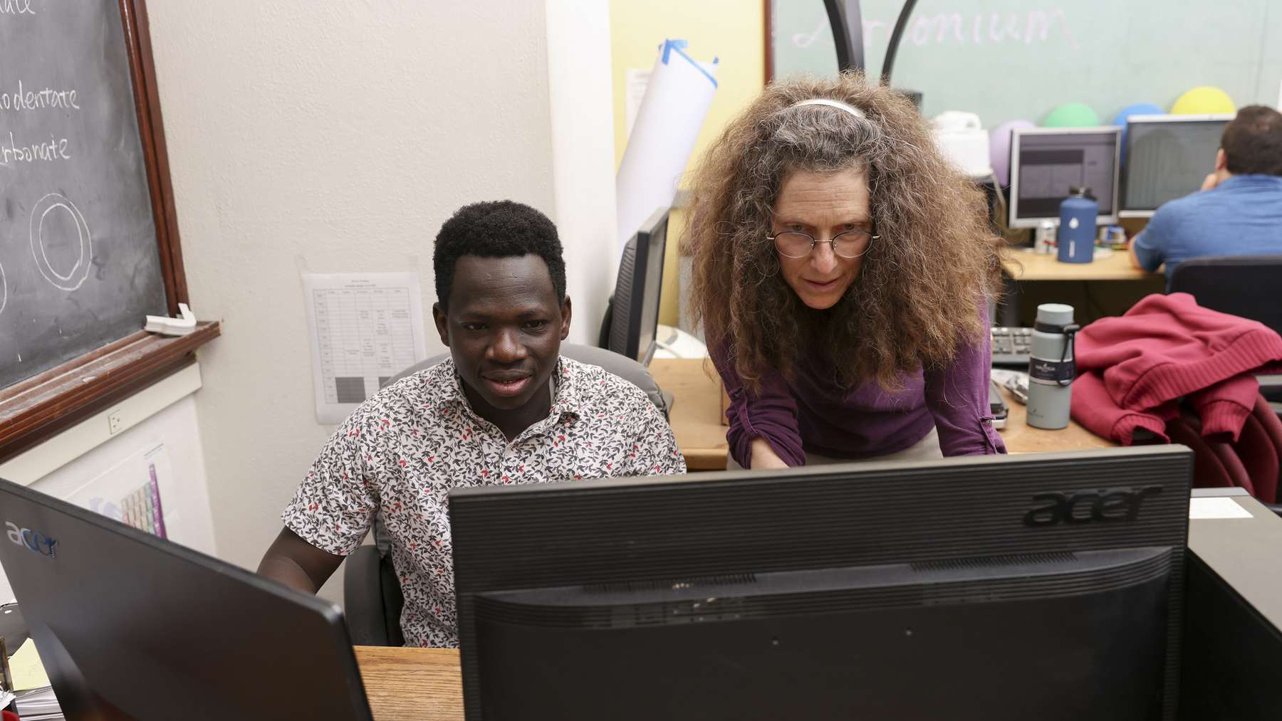 May Nyman and Doctor Stephen, co-authors of the zirconium and hafnium separation study, look at a computer screen at Oregon State University