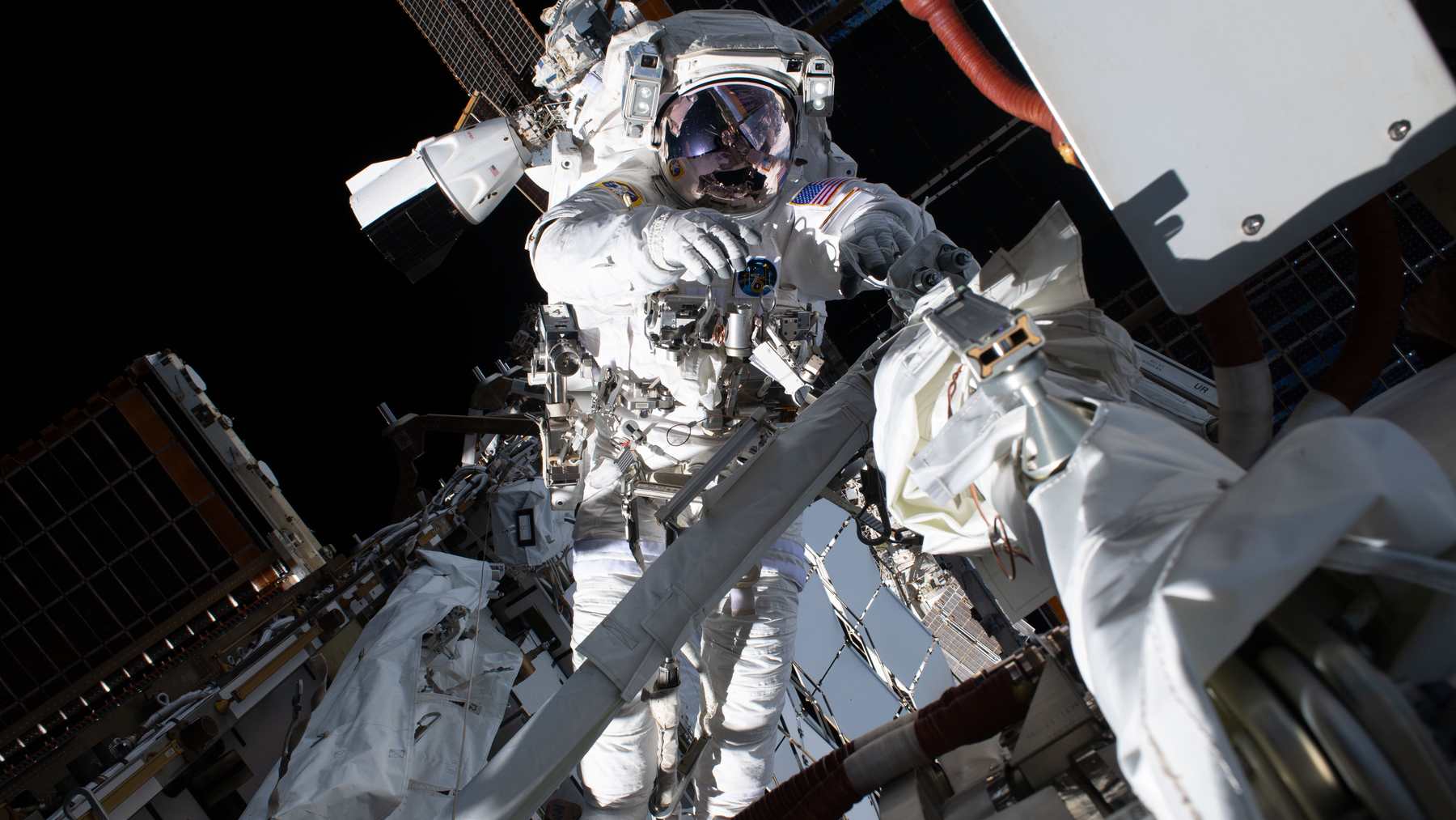 NASA astronaut Anil Menon on an Aug. 6, 2026, spacewalk outside the International Space Station to prepare for new roll-out solar arrays