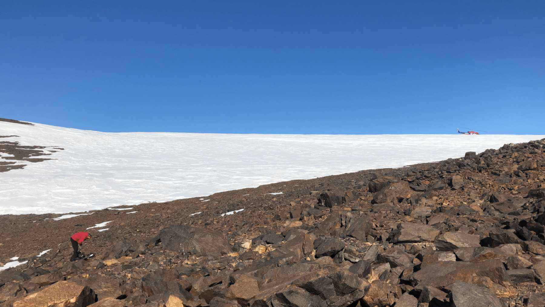 Researcher collecting soil samples near Shackleton Glacier, where Antarctica's own soil bacteria were sampled
