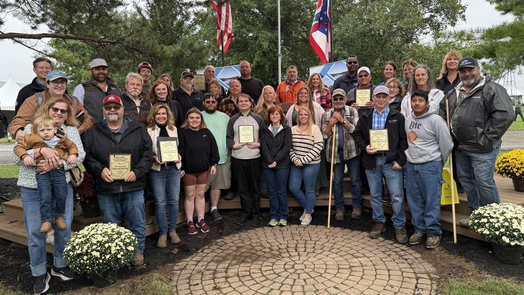 The 2026 Ohio Conservation Farm Family Award winners holding their plaques at the Farm Science Review