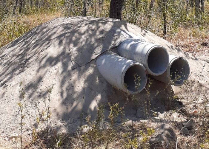 Artificial quoll den made of three pipes set into a mound of earth at Brooklyn Wildlife Sanctuary, Queensland