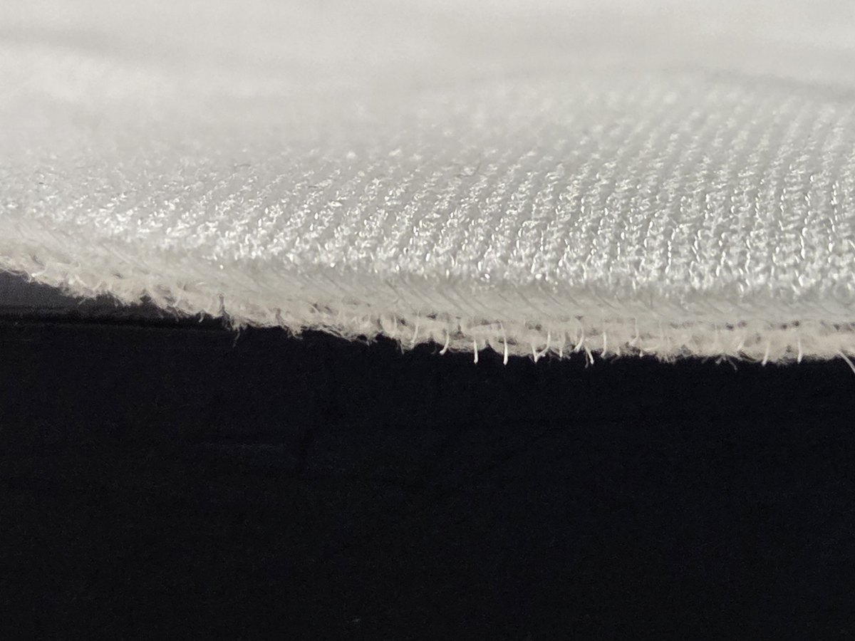 Close-up of the edge of a white knitted textile