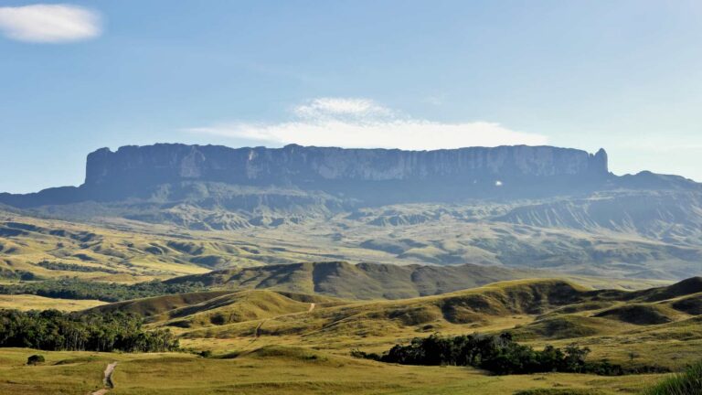 Mount Roraima rising above the Gran Sabana grasslands of Venezuela, its flat summit and sheer walls seen from the route that leads to it from Paraitepui