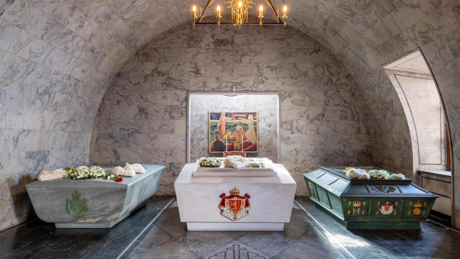 Three sarcophagi in a vaulted marble chamber, with a gray-green stone sarcophagus on the left