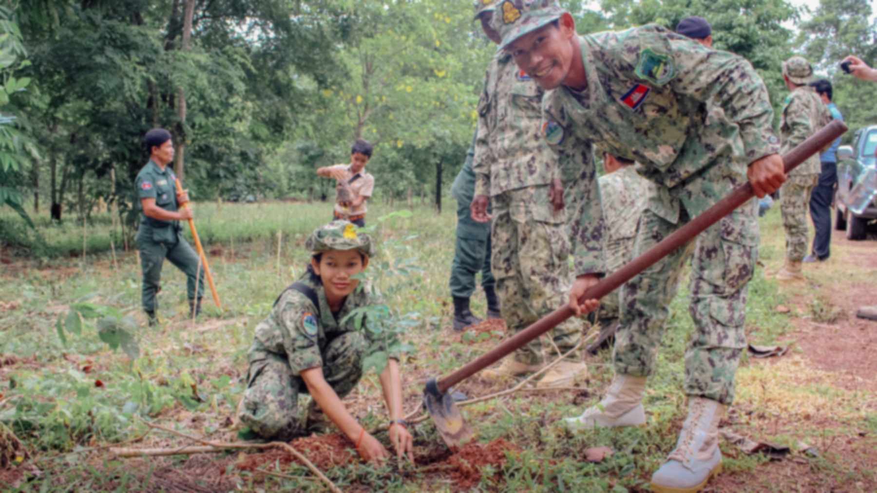 Rangers supported by Angelina Jolie's foundation planting a tree seedling in the Samlaut forest in northwestern Cambodia