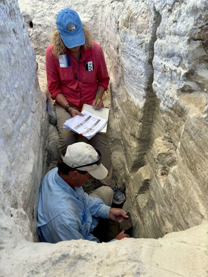 USGS geologists Kathleen Springer and Jeffrey Pigati collecting sediment samples inside the trench at White Sands National Park