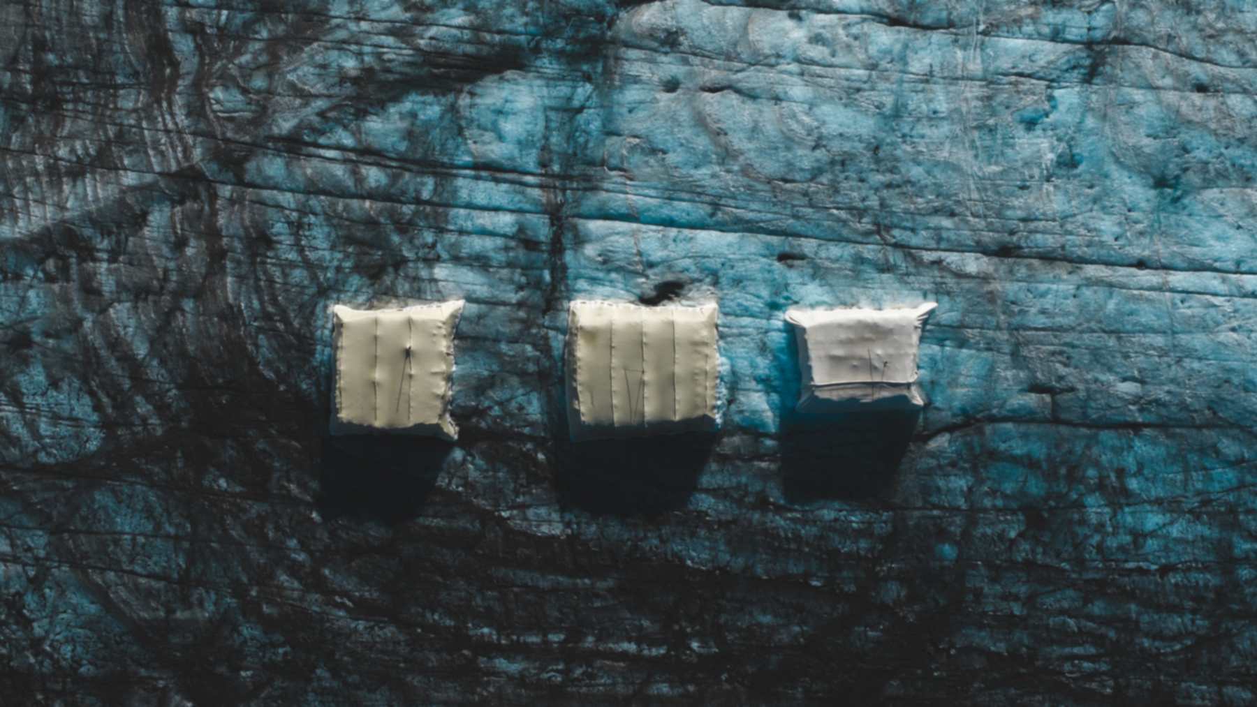 Aerial view of the sheep's wool covers and a synthetic cover side by side on the ice at Glacier 3000