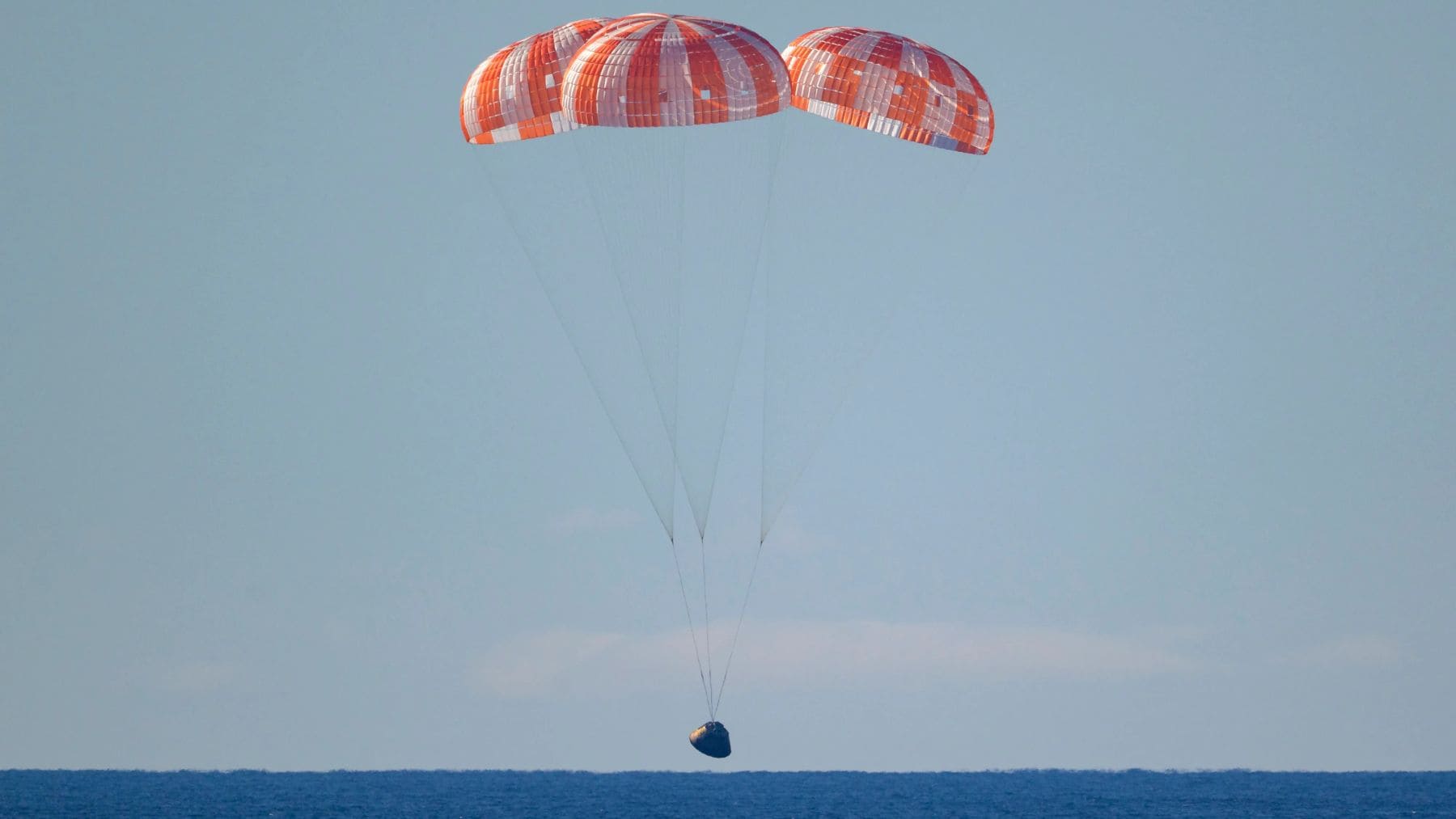 Cápsula Orion de Artemis II amerizando en el océano Pacífico tras misión lunar con astronautas de la NASA.