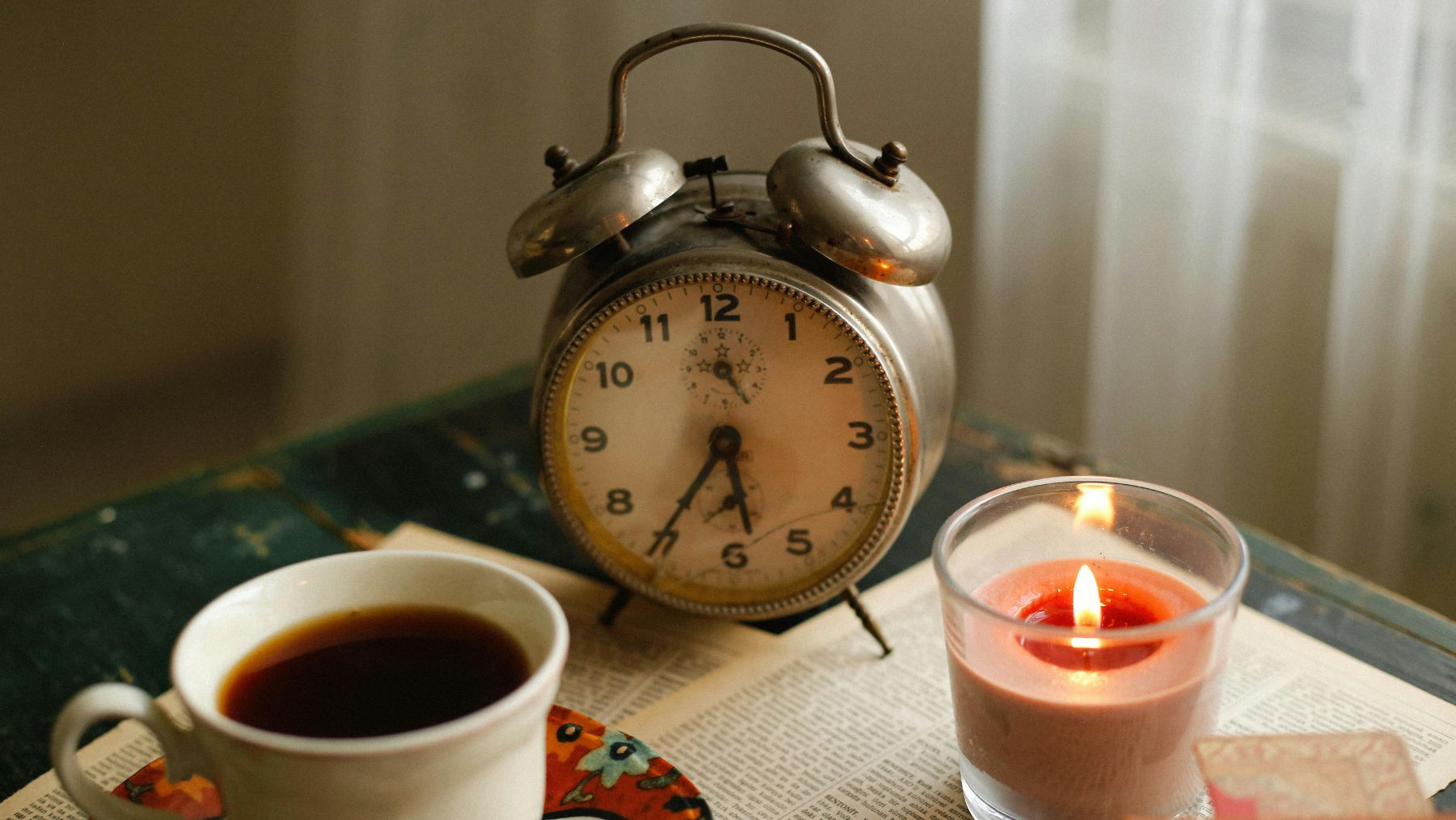Reloj antiguo sobre una mesa que simboliza cómo percibimos que el tiempo pasa más rápido con la edad.