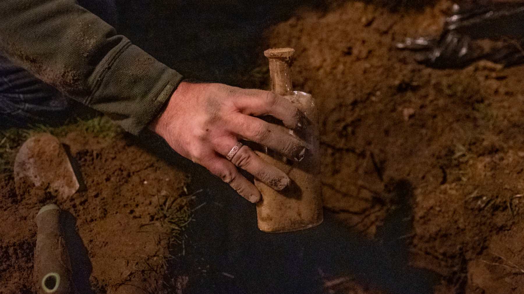 Una mano sujeta la botella del experimento de Beal recién desenterrada en el campus de la Universidad Estatal de Michigan