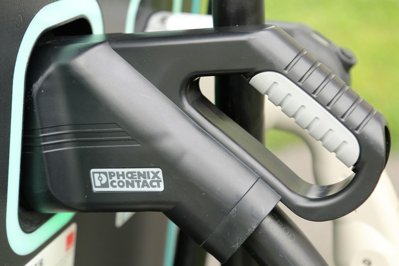 Vista de camiones y autobuses junto a puntos de recarga eléctrica e hidrogeneras en España financiados por Bruselas para descarbonizar el transporte