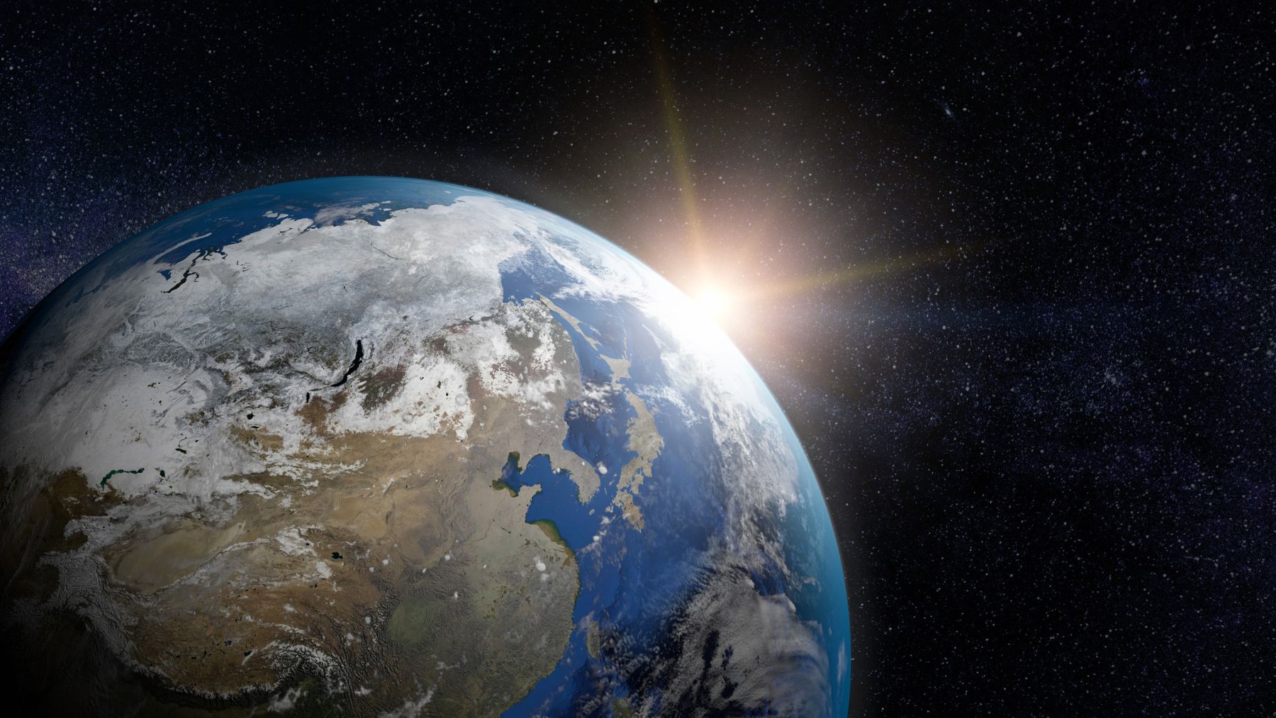 La Tierra vista desde el espacio con el Sol iluminando la órbita donde Japón probará energía solar espacial.