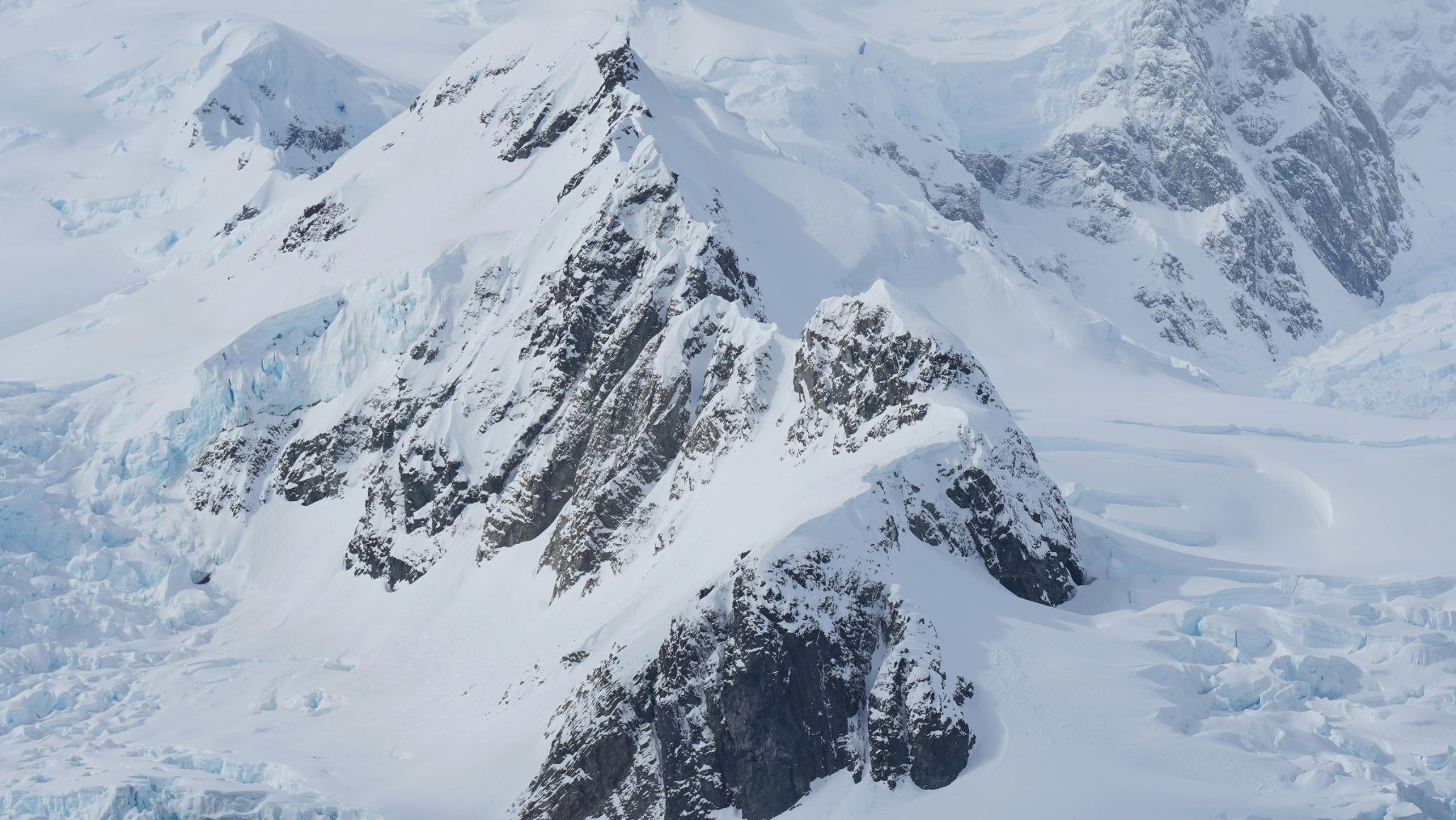 Montañas cubiertas de hielo en la Península Antártica afectadas por el aumento de temperaturas y la lluvia.