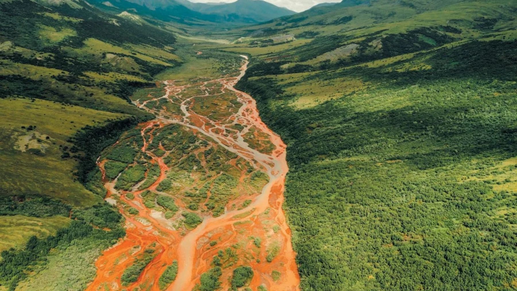 Río teñido de color naranja por la liberación de metales tóxicos tras el deshielo del permafrost en Canadá.