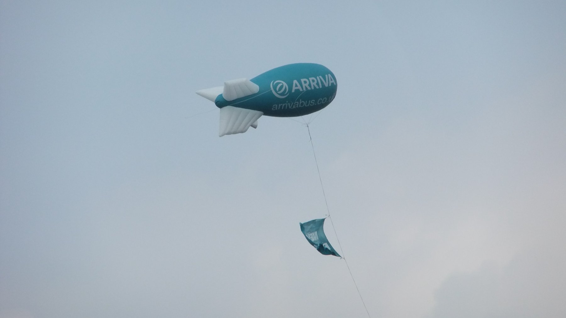 Globo cautivo con forma de dirigible sujeto al suelo por un cable